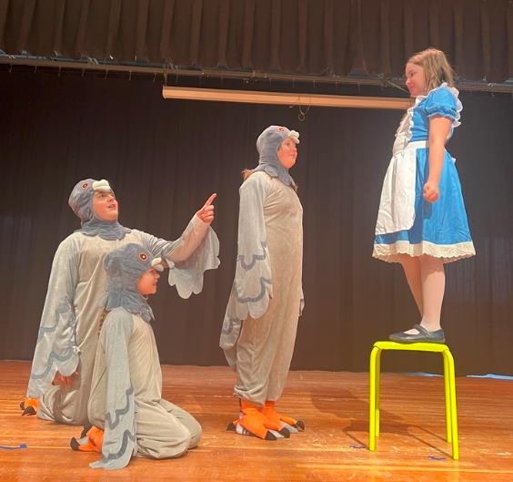 Alice grows in Alice in Wonderland play
